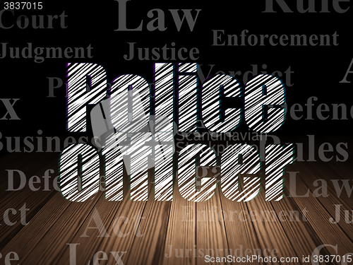 Image of Law concept: Police Officer in grunge dark room