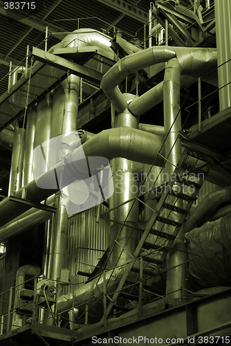 Image of Pipes and tubes and chimney at a power plant