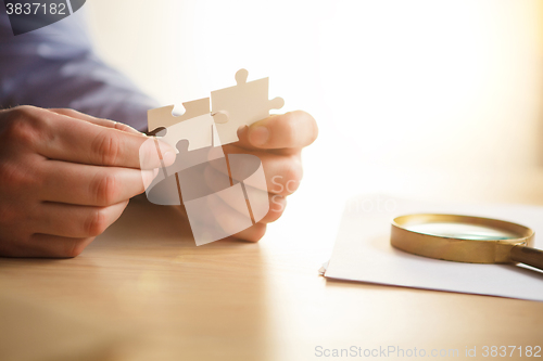 Image of Building a business success. The hands with puzzles