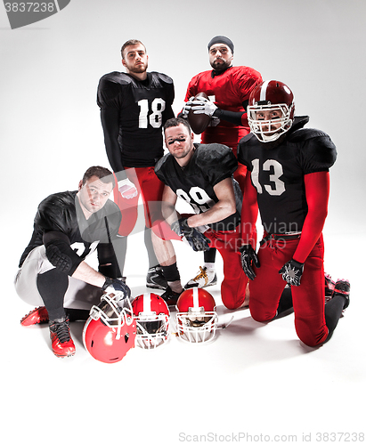 Image of The five american football players posing with ball on white background