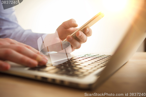 Image of The male hand holding a phone 