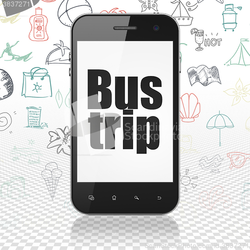 Image of Tourism concept: Smartphone with Bus Trip on display