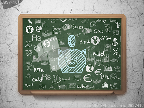 Image of Money concept: Money Box With Coin on School Board background