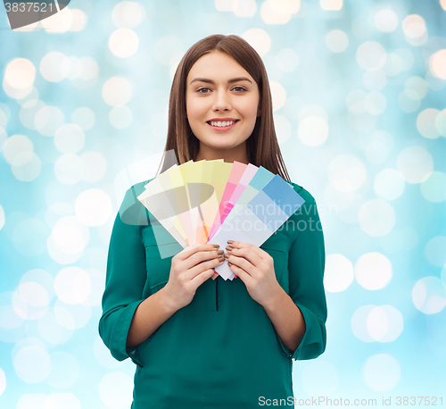 Image of smiling young woman with color swatches