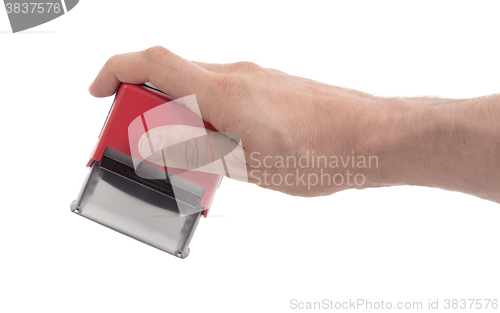 Image of Plastic stamp in hand, isolated