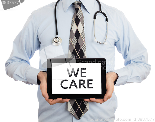 Image of Doctor holding tablet - We care