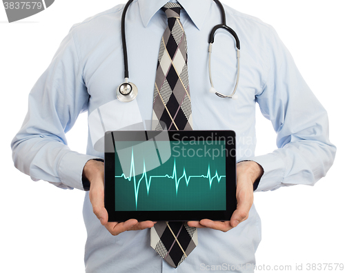 Image of Doctor holding tablet - Heartbeat graph