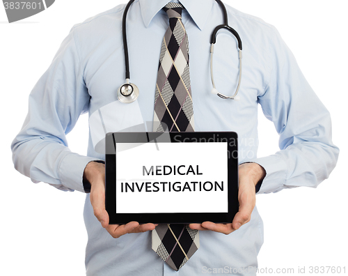 Image of Doctor holding tablet - Medical investigation