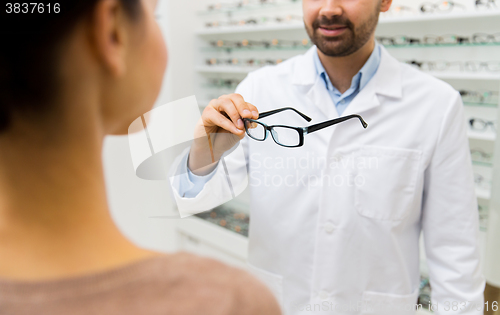 Image of close up of optician with glasses at optics store