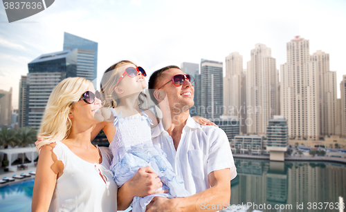 Image of happy family over dubai city background