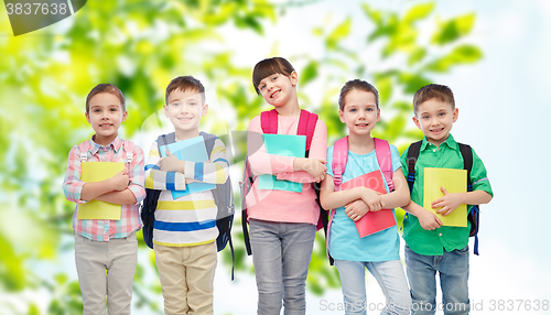 Image of happy children with school bags and notebooks