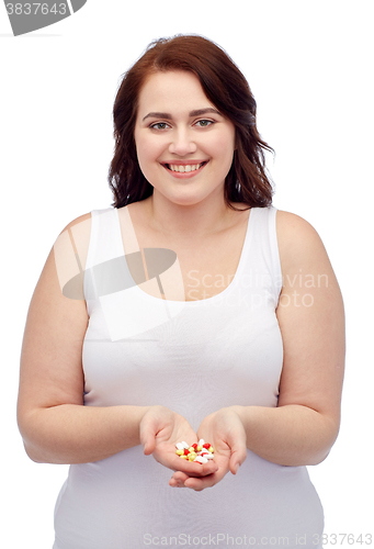 Image of happy plus size woman in underwear with pills