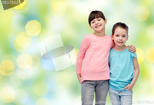 Image of happy smiling little girls hugging