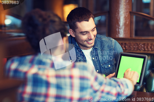 Image of male friends with tablet pc at bar