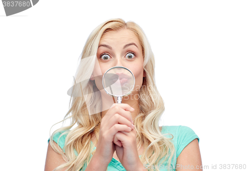 Image of happy young woman with magnifying glass