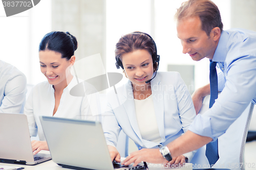 Image of group of people working in call center