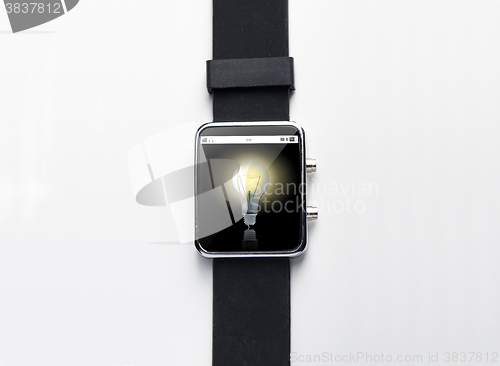 Image of close up of smart watch with light bulb on screen