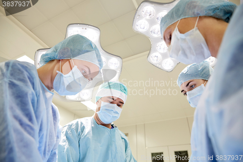 Image of group of surgeons in operating room at hospital