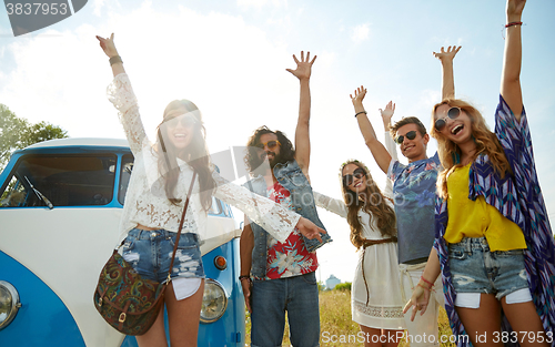 Image of smiling hippie friends having fun over minivan car