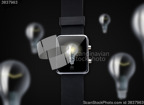 Image of close up of smart watch with light bulb on screen