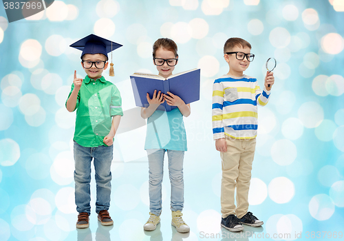 Image of kids in glasses with book, lense and bachelor hat