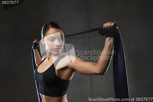 Image of woman with expander exercising in gym