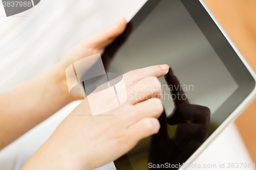 Image of close up of woman hand with tablet pc at home