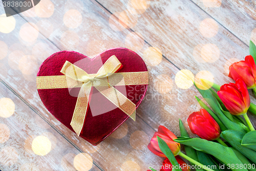 Image of close up of red tulips and chocolate box