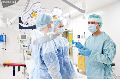 Image of group of surgeons in operating room at hospital