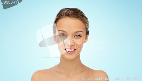 Image of smiling young woman face and shoulders