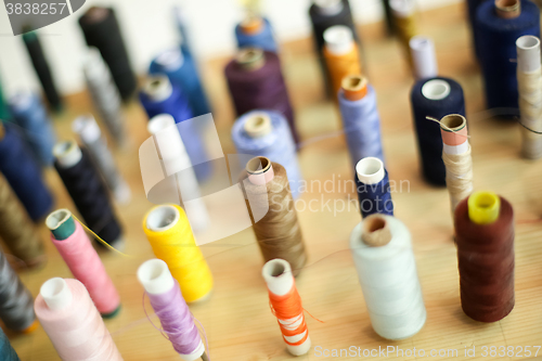 Image of Group of sewing threads on wooden board