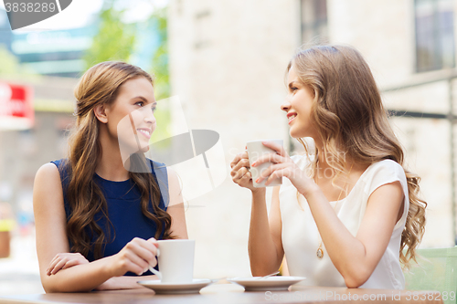 Image of young women drinking coffee and talking at cafe