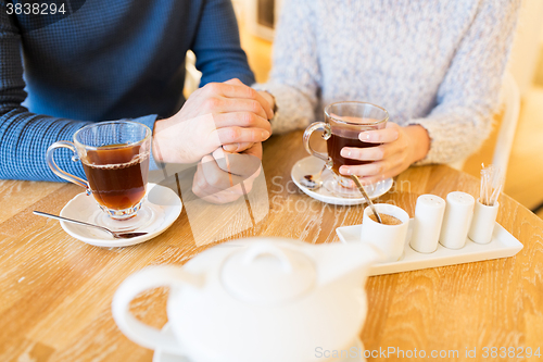 Image of close up of couple drinking tea at cafe