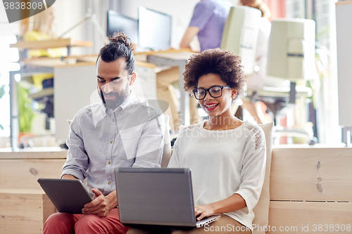 Image of creative team with laptop and tablet pc in office