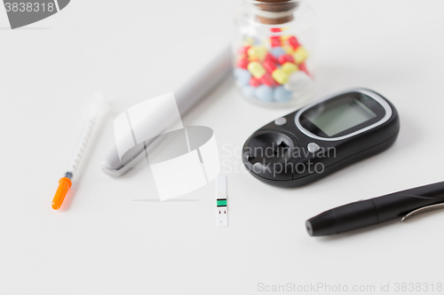 Image of close up of blood sugar test stripe and glucometer