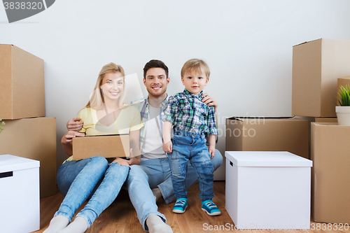 Image of happy family with boxes moving to new home