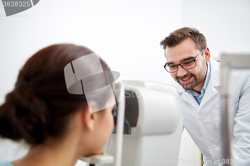 Image of optician with tonometer and patient at eye clinic