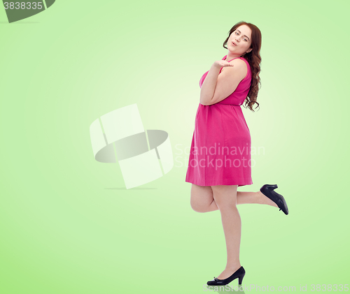 Image of happy young plus size woman and sending blow kiss