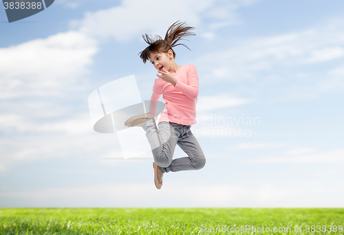 Image of happy little girl jumping in air
