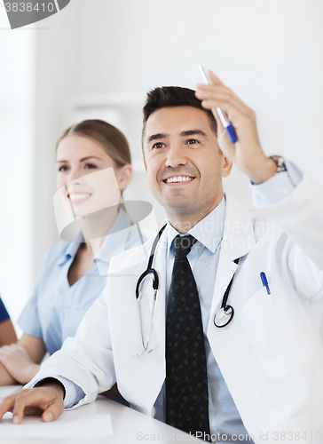 Image of group of happy doctors on conference at hospital