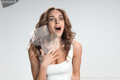 Image of Portrait of young woman with shocked facial expression