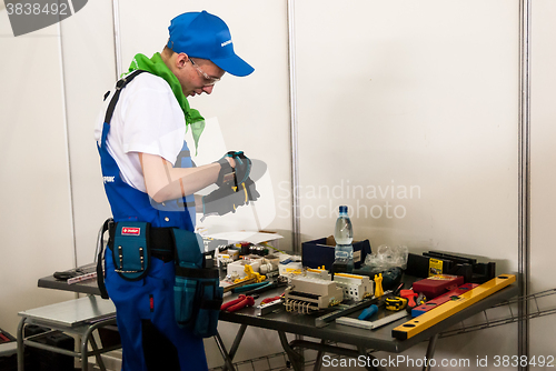 Image of Young electrician performs task of competition