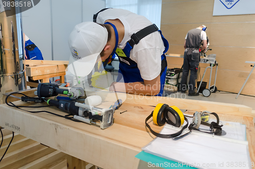 Image of Young carpenter performs task of competition