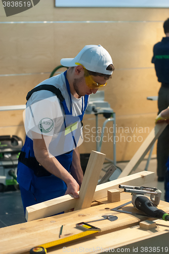 Image of Young carpenter performs task of competition