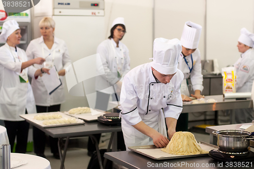 Image of Cooks prepare food in competition