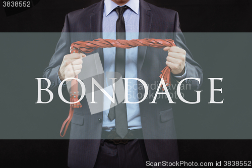 Image of man in business suit with chained hands. handcuffs for sex games. concept of erotic entertainment. bondage