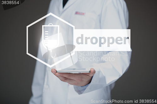 Image of Doctor working on a virtual screen. medical technology concept. dropper