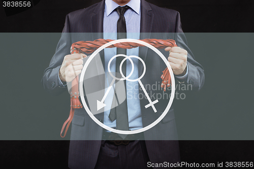 Image of man in business suit with chained hands. handcuffs for sex games. concept of erotic entertainment.