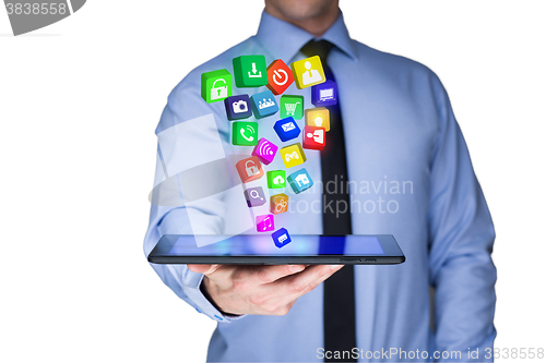 Image of Businessman holding a tablet pc with mobile applications icons on virtual screen . Internet and business concept.