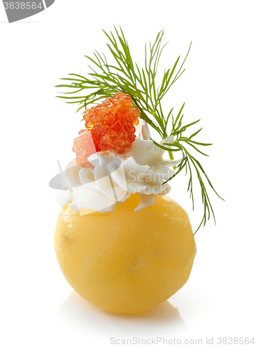 Image of boiled potato decorated with cream cheese, red caviar and dill